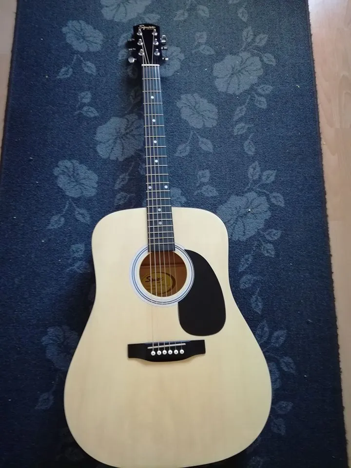 A budget laminate-top acoustic guitar of the kind sold in starter bundles