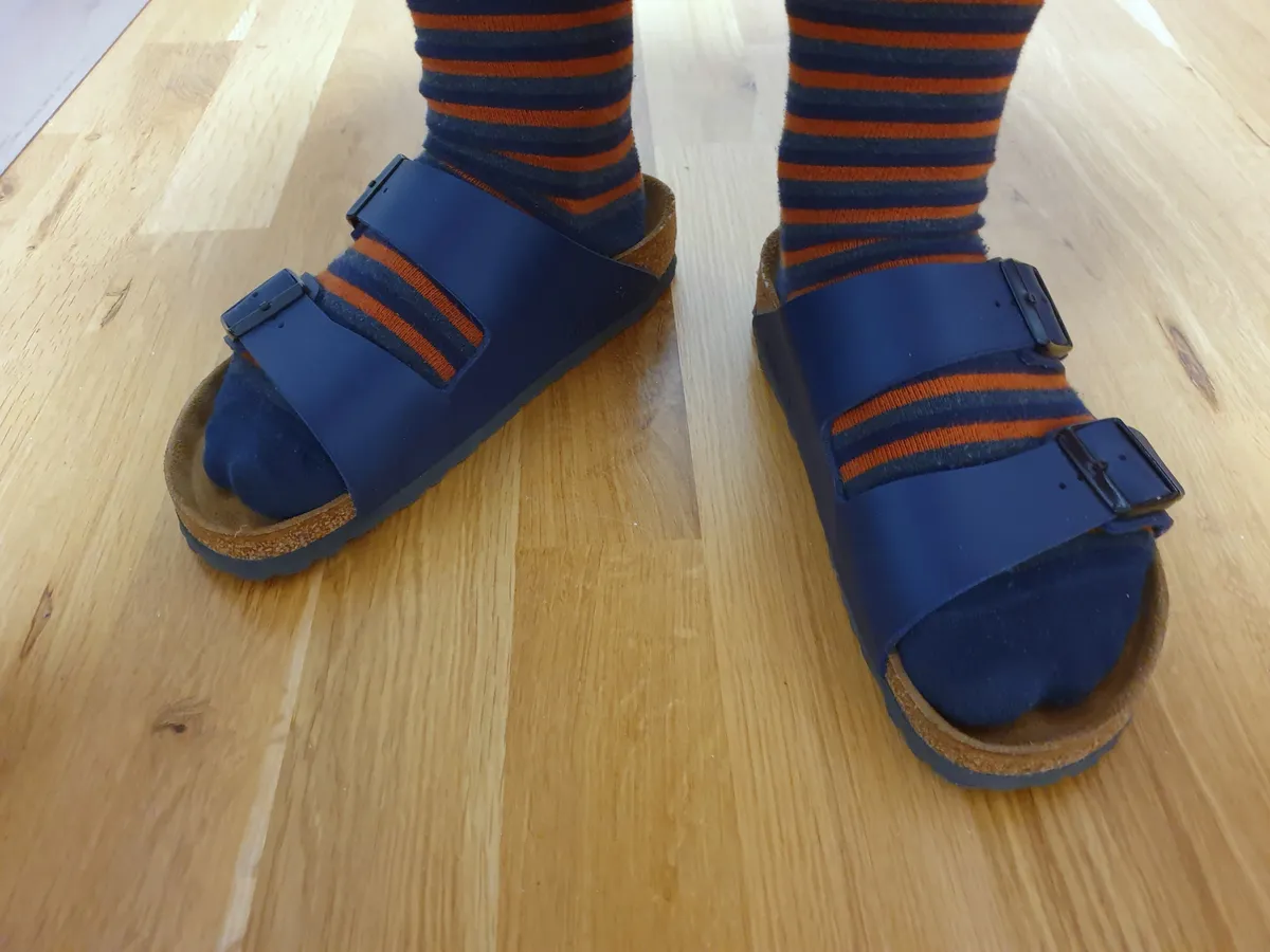 Blue Birkenstock Arizona sandals with buckled straps