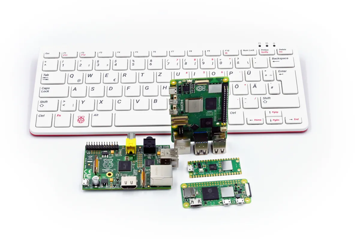 Raspberry Pi 5 photographed alongside a Pi 1, Pi 400, Zero 2 and Pico for size comparison
