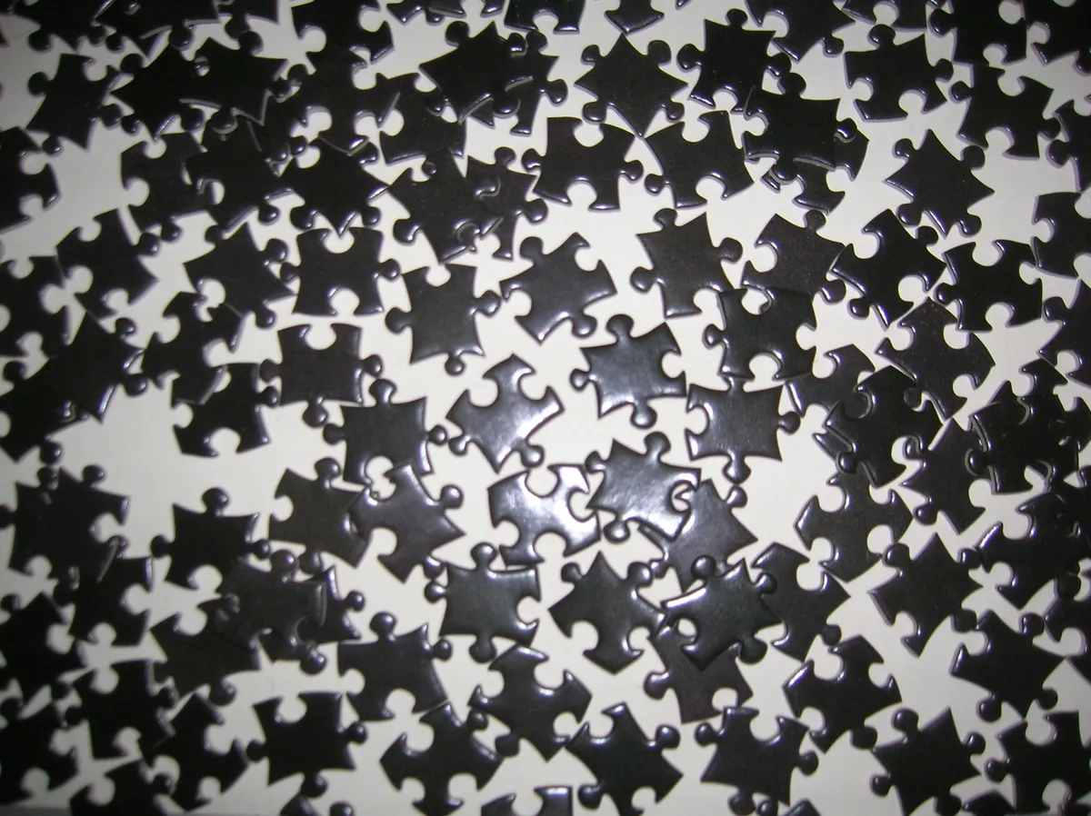 Close-up of jigsaw puzzle pieces showing knob and socket shapes
