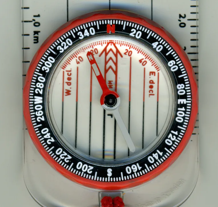 Close-up of a compass bezel showing the azimuth scale, declination markings and orienting lines