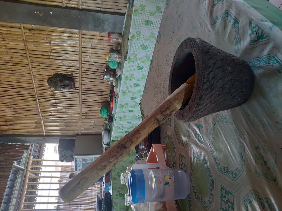 A stone mortar being used to grind ingredients for cooking