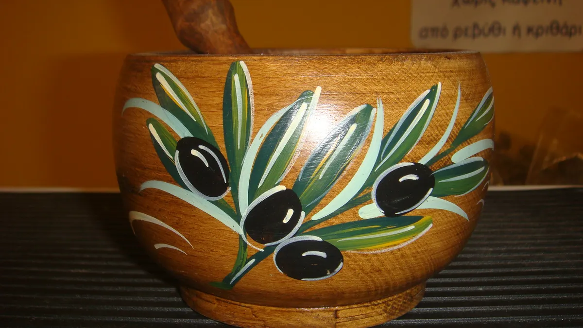 A decorated wooden mortar and pestle, lighter but softer than stone