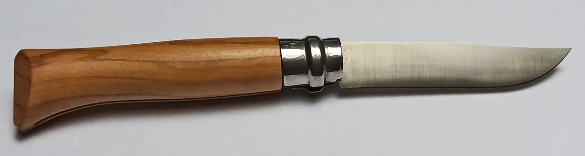 Opinel folding knife shown open on a plain background