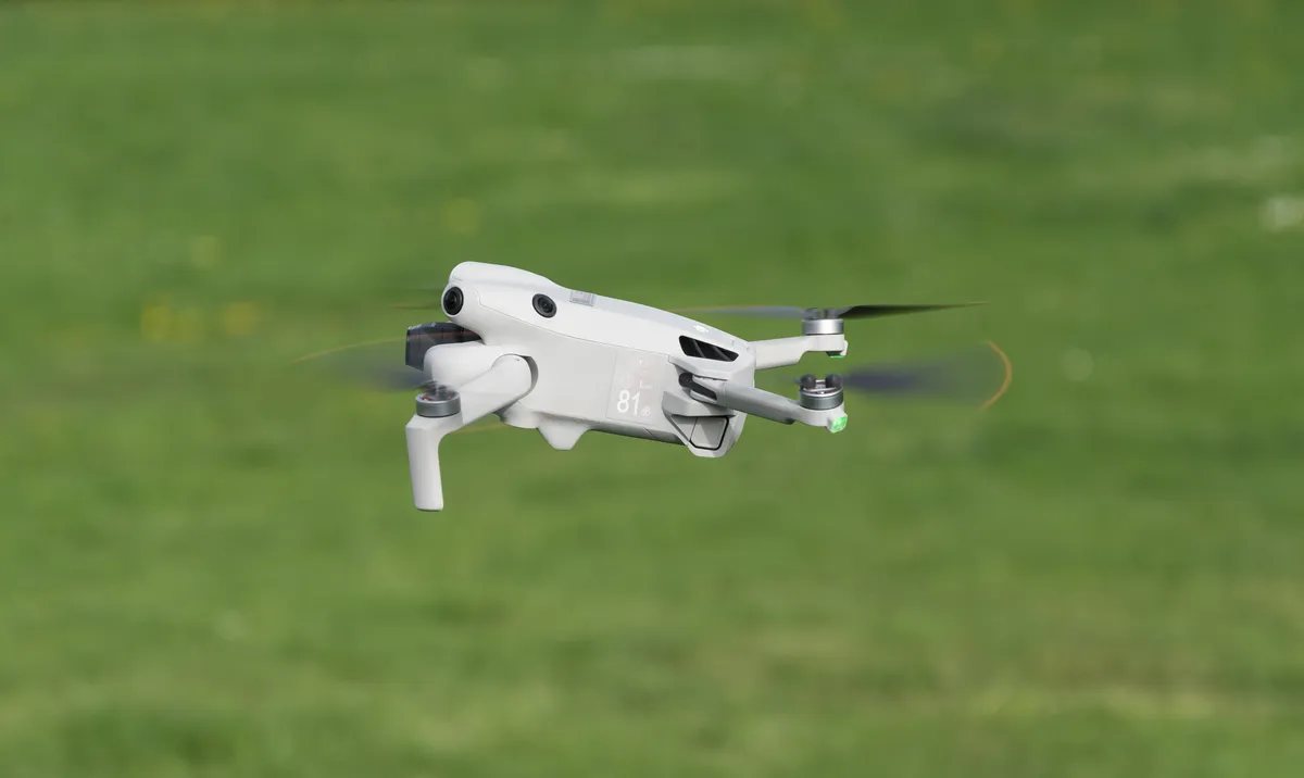 DJI Mini 4 Pro drone photographed from above showing the airframe layout