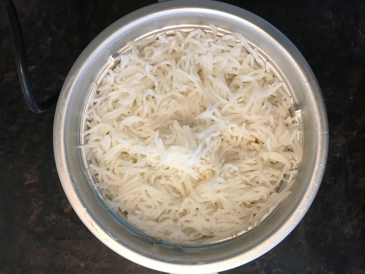 Cooked white rice in the bowl of an electric rice cooker