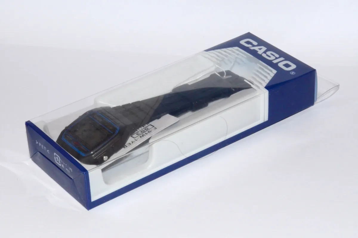 Casio F-91W with its retail packaging and included documentation