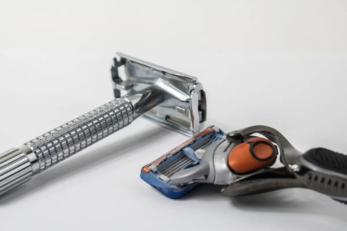 A cartridge razor and a double-edge safety razor shown side by side