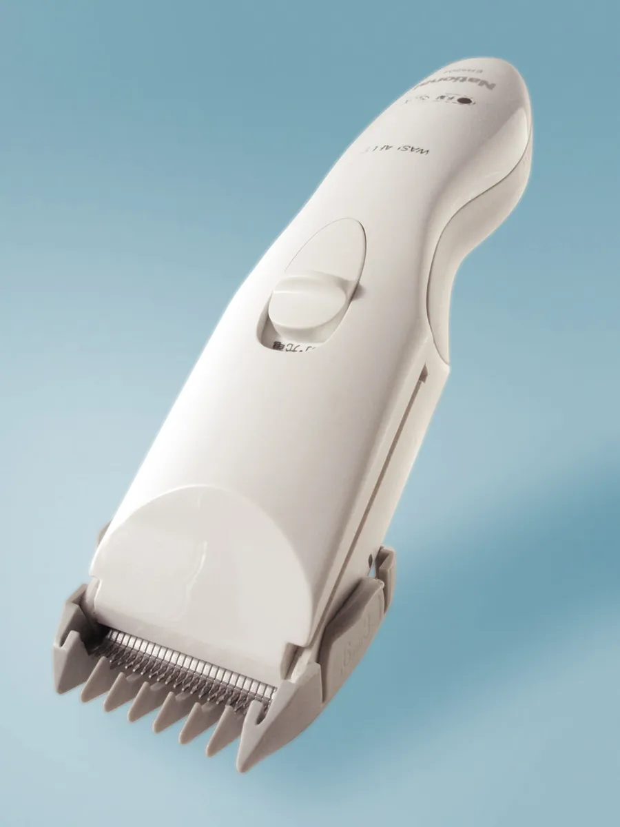 Electric hair clipper showing the cutting blade and taper lever