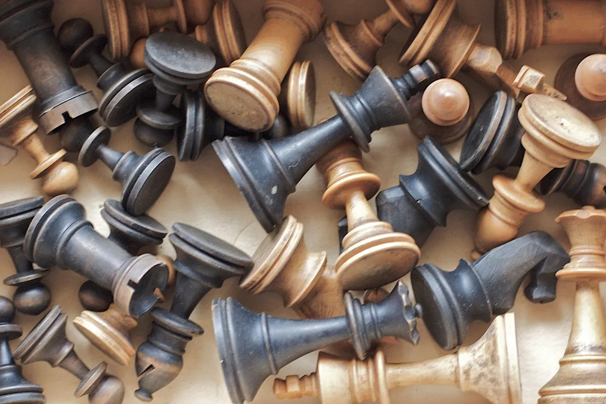 Wooden chess set with pieces set up for a game