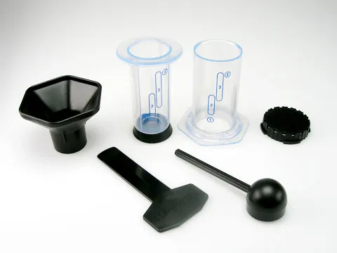 AeroPress standing on a cup ready to brew with filters alongside