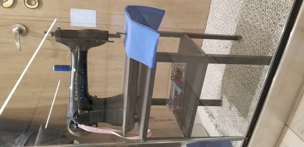 A vintage all-metal Singer sewing machine, illustrating the older mechanical design