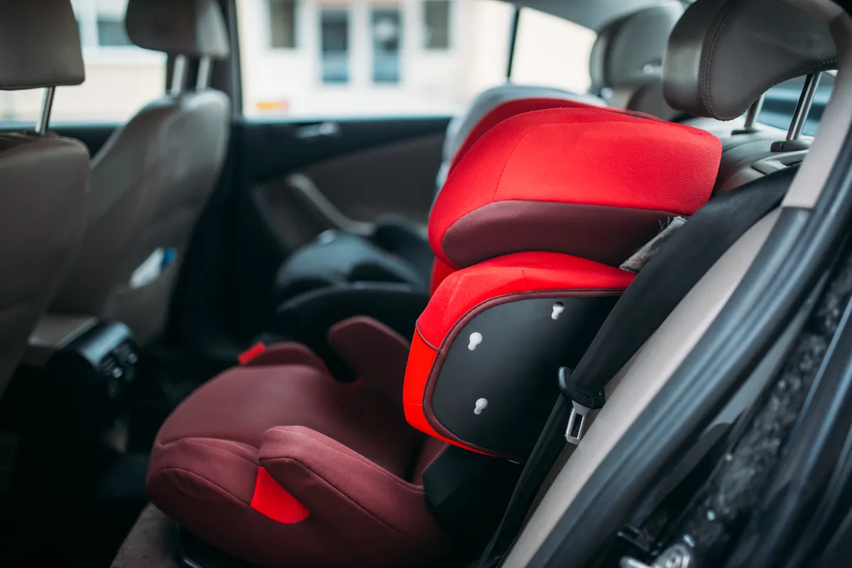 Close view of a modern child car seat harness and padding
