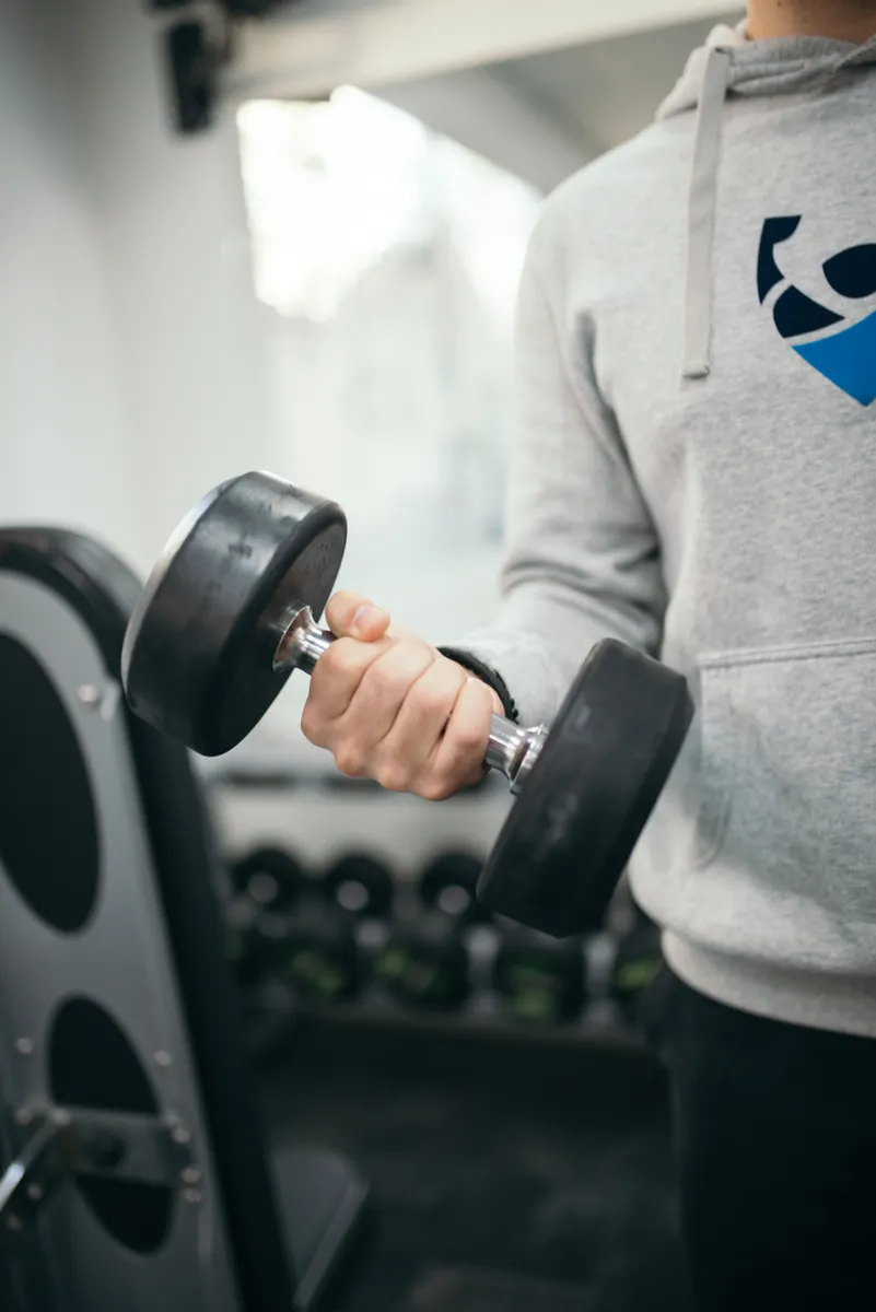 A hand gripping a dumbbell