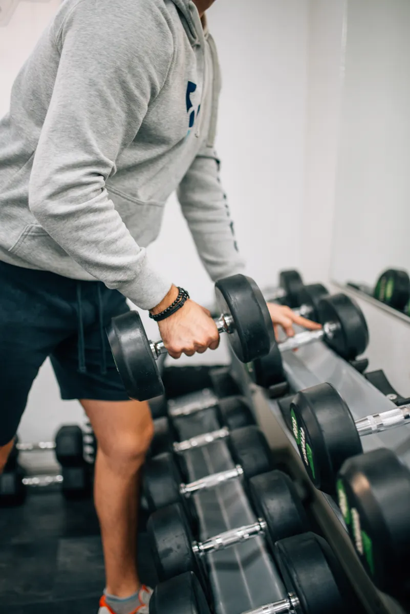 A person lifting a dumbbell during a workout