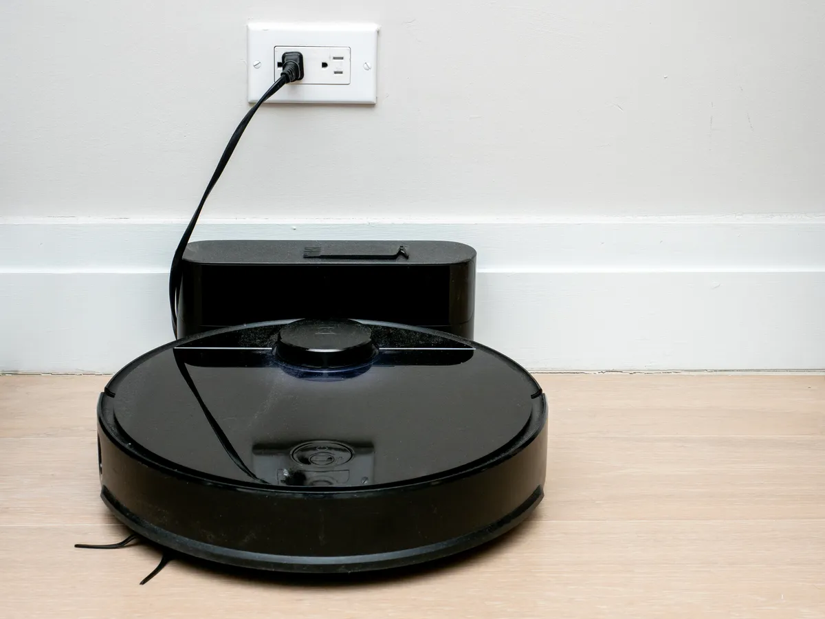Robot vacuum resting at its charging dock in a living room