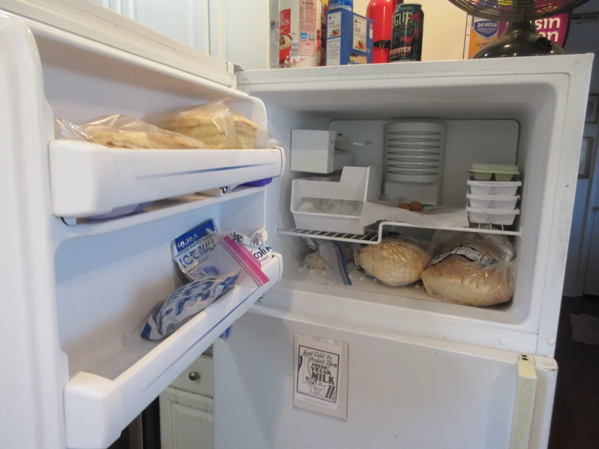 An open freezer compartment on a home refrigerator