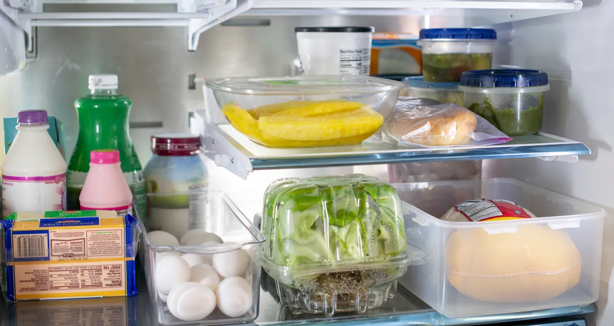Food stored in labelled containers inside a refrigerator