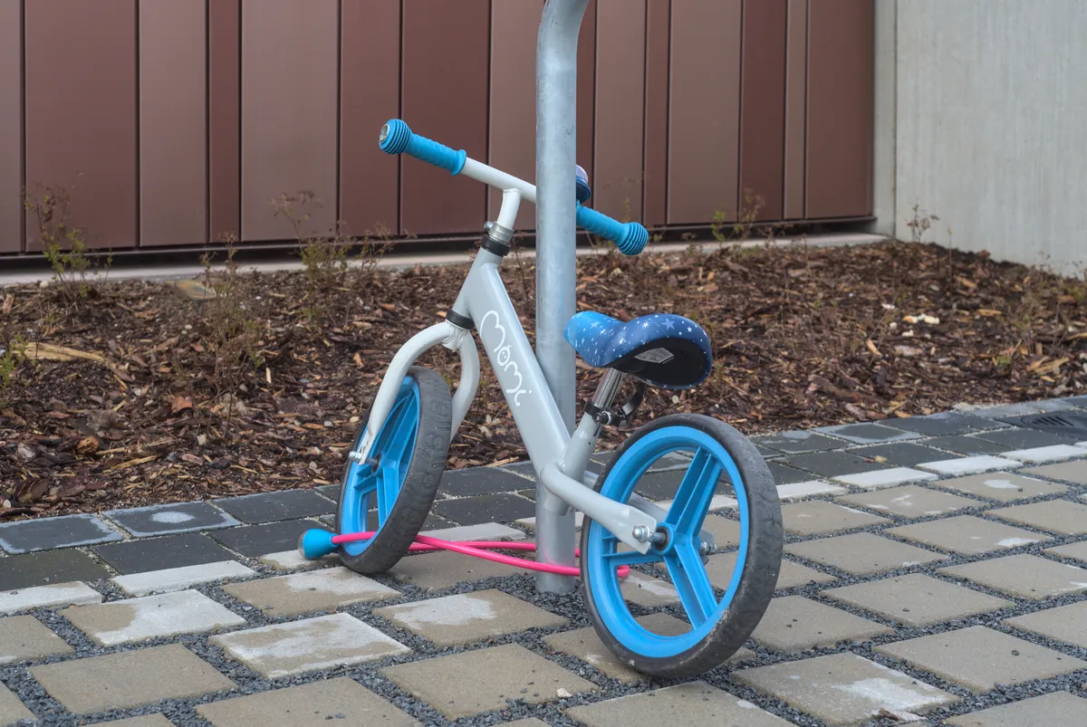 Close view of a balance bike frame, saddle and foam tyre