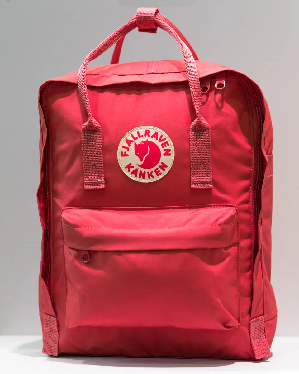 A backpack on display at an outdoor gear trade show, illustrating the broader daypack category