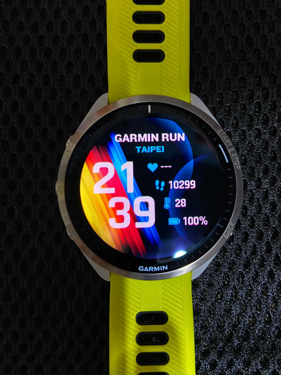 Garmin Forerunner AMOLED running watch showing a custom watch face