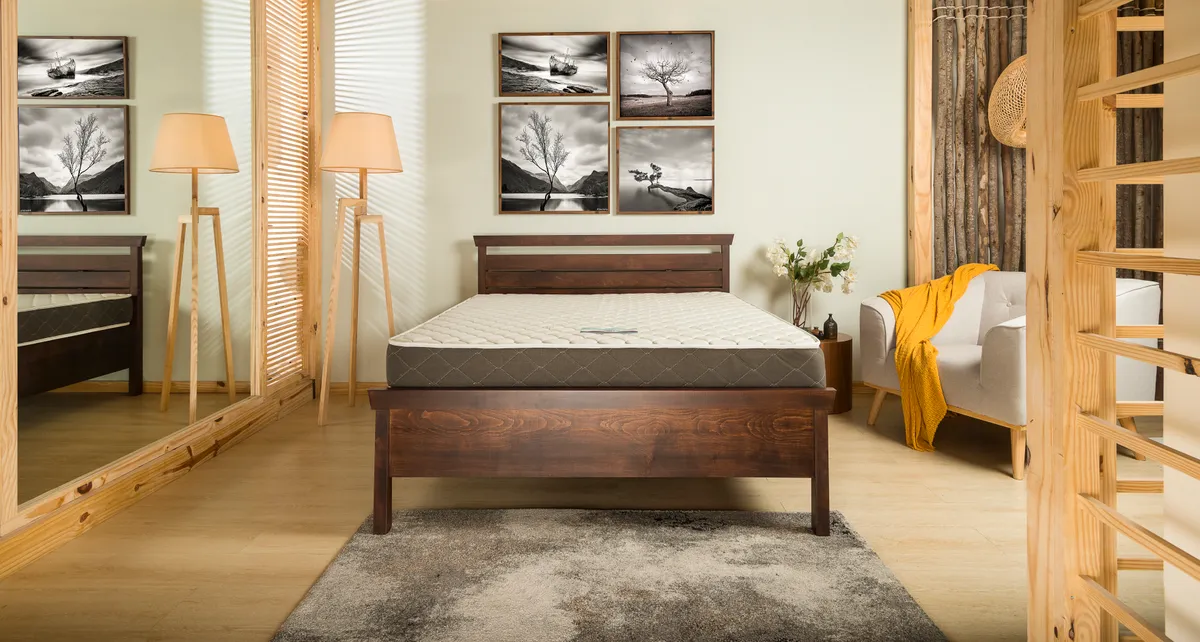 Mattress on a bed frame in a bedroom setting